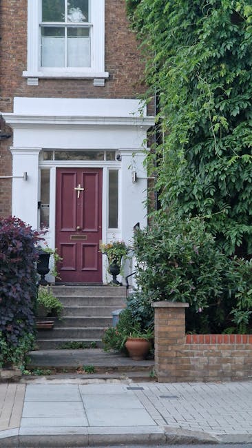 A close-up view of the front entrance of a brick-built house in Purley, featuring a maroon front door with a brass letterbox and door knocker, bordered by white decorative trim and a transom window ab